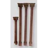 Three carved pine Corinthian columns, 105cms tall together with another similar smaller column,