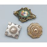 A Victorian mourning brooch together with a silver brooch and a micro-mosaic brooch