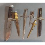 A letter opener in the form of a German dagger, together with two other letter openers in the form