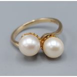 A 9ct yellow gold pearl ring set with two pearls in a crossover setting, ring size O, 3.1gms