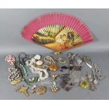 A collection of jewellery to include brooches, dress rings and other jewellery together with a fan