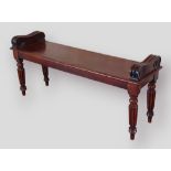 A William IV mahogany window seat with scroll ends raised upon turned reeded legs, 122cms wide by