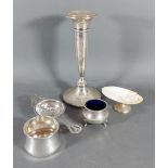 A silver candlestick, (marks rubbed) 17.5cms tall, together with a Birmingham silver tea strainer,