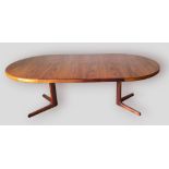 A late 20th Century Danish circular extending dining table with two extra leaves, 120cms x 220cms