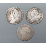 A George II silver shilling, dated 1743, A Queen Anne silver shilling, dated 1707 and a Victorian