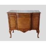 A Circa 1920's Queen Anne style walnut side cabinet , the moulded top above a central door flanked