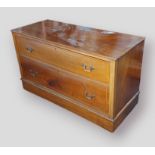 A mahogany chest of two drawers with brass handles raised upon a plinth base,113cms wide by 48cms