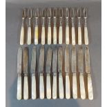 A set of eleven George III silver dessert knives and forks with carved mother of pearl handles,