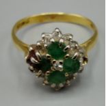 A 18ct yellow gold emerald and diamond cluster ring set four emeralds surrounded by diamonds