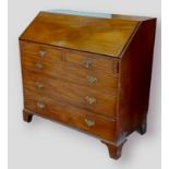 A 19th Century mahogany bureau, the fall front above two short and three long drawers raised upon