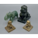 A pair of Chinese brass seals in the form of Dogs Of Fo together with a jade model of an elephant