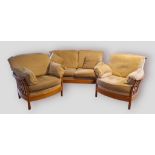 An Ercol Renaissance three piece suite comprising a two seat sofa and a pair of matching armchairs