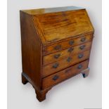 A George III mahogany bureau, the fall front enclosing a fitted interior above four long drawers