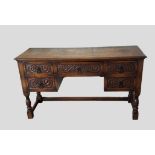 An oak side table with five carved drawers raised upon turned legs with stretchers, 138cms wide,