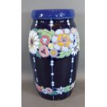 A Czechoslovakian vase decorated in polychrome enamels upon a blue ground, 32cms tall