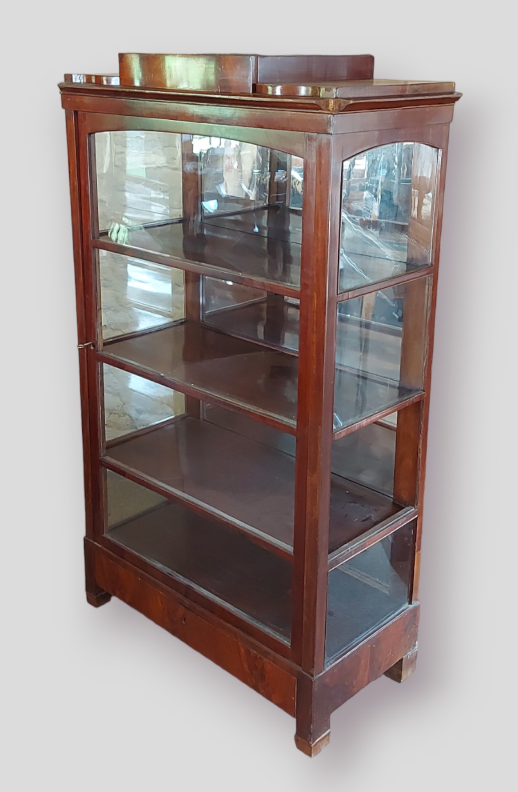 A 19th Century Continental mahogany display cabinet with a single glazed door enclosing shelves