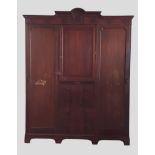 An Edwardian mahogany and satinwood inlaid wardrobe, the moulded cornice above a central door and