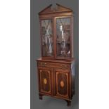 An Edwardian mahogany and satinwood inlaid cabinet with mounded split pediment above two astragal