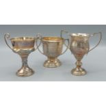 A Birmingham silver two handled trophy cup together with two other Birmingham silver trophy cups,