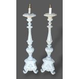 A pair of 18th Century style lamp standards with tri-form bases, 100cms tall together with a set