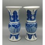 A pair of early 19th Century Chinese flared rim vases, underglaze blue decorated with serpents and