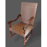 A French carved walnut armchair with a padded back and seat with scroll arms and similar legs with