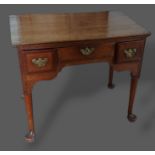 A George III oak lowboy, with three drawers above turned tapering legs with pad feet, 81cms wide,