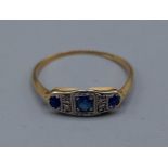 An 18ct gold Diamond and Sapphire ring, set with three Sapphires and four Diamonds, ring size L