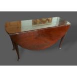A George III mahogany drop flap dining table with carved cabriole legs and pad feet, 137cms x 146cms