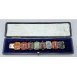 A multi-coloured Agate and yellow metal panel bracelet, 17cms long