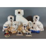 A pair of Staffordshire models of Spaniels together with other related ceramics