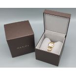A gold plated ladies wristwatch by Gucci, the M.O.P. dial set with diamond markers, complete with