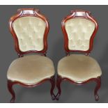 A pair of 19th Century French mahogany side chairs, each with a partly button upholstered back above