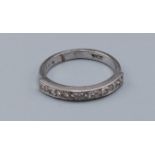 An 18ct white gold and diamond set half eternity ring, ring size L, 3.7gms