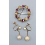 A 9ct yellow gold and garnet brooch in the form of a wreath set six garnets, 3.2gms, together with a
