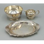 An Edwardian silver sugar bowl, Chester 1909, together with a London silver cream jug and a