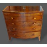 A 19th Century mahogany and satinwood crossbanded bow fronted chest with four long drawers raised
