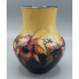 A Moorcroft Orchid pattern vase, tube lined, 18cms tall