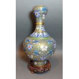 A chinese Champleve bottle neck vase, decorated in polychrome enamels, 26cms tall