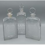 A pair of 18th Century glass decanters each with etched decoration together with another similar