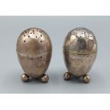 A pair of Victorian silver peppers of egg form, Birmingham 1879