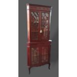 An Edwardian mahogany satinwood inlaid standing corner cabinet with four astragal glazed doors