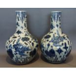 A pair of Chinese underglaze blue decorated bottle neck large vases each decorated with carp amongst