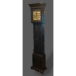 An oak longcase clock, the square hood above a shaped door raised upon ogee bracket feet, the