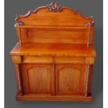 A Victorian mahogany chiffonier with a shaped back above two frieze drawers and two cupboard doors