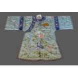 A Chinese silkwork Kimono, decorated with exotic birds amongst foliage upon a blue ground