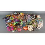 A large collection of jewellery to include bead necklaces, brooches and bangles