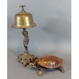 An early 20th Century desk bell in the form of a Tortoise together with a brass desk bell