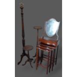 A mahogany lamp standard together with a mahogany torchere, a similar wine table, a nest of three
