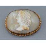 A 9ct gold framed oval cameo brooch relief decorated with a bust, 5cms by 3.5cm